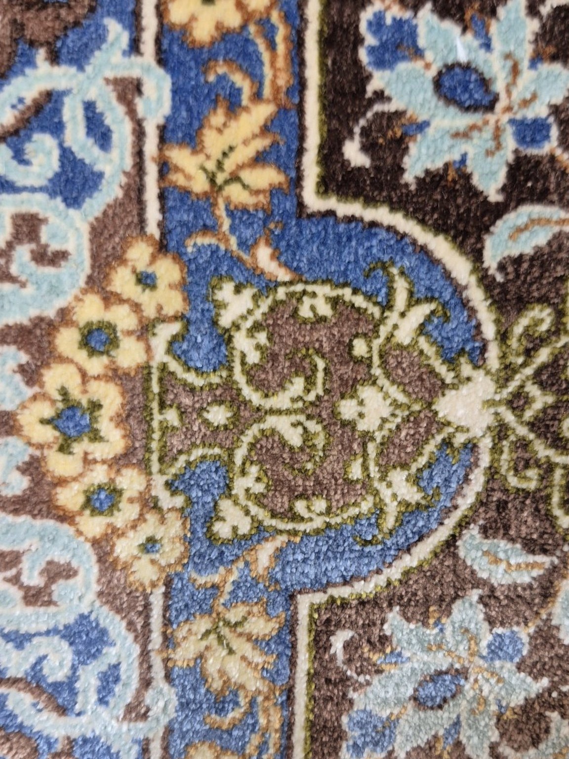 The same area after reweaving, with the medallion pattern running unbroken