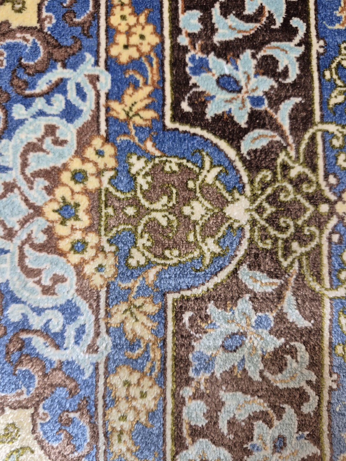The same area after reweaving, with the medallion pattern running unbroken