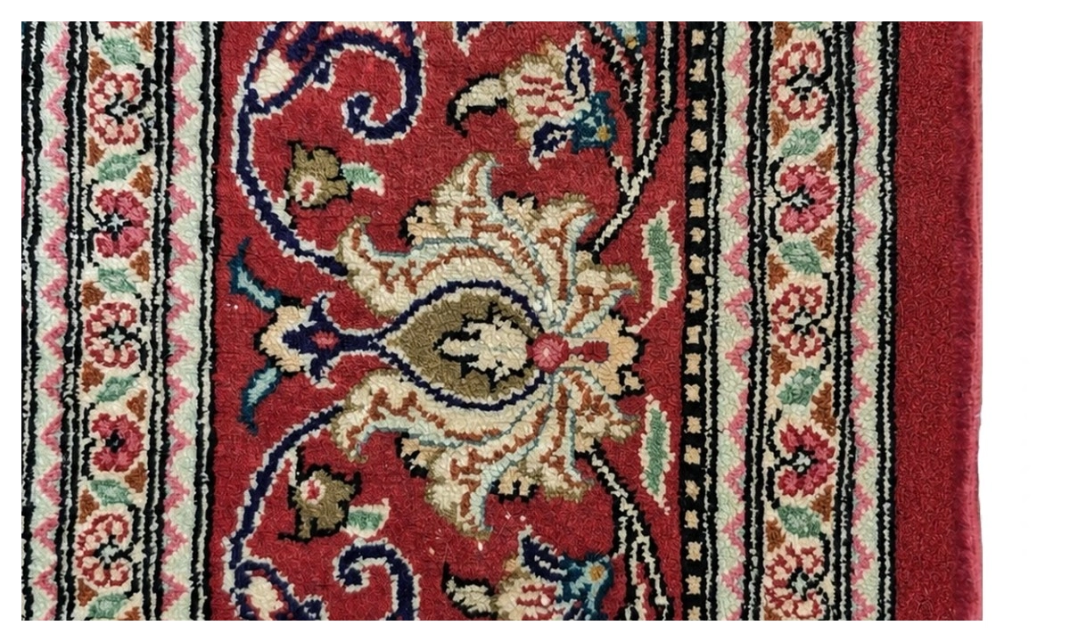 Red Persian rug edge after side cord rebinding