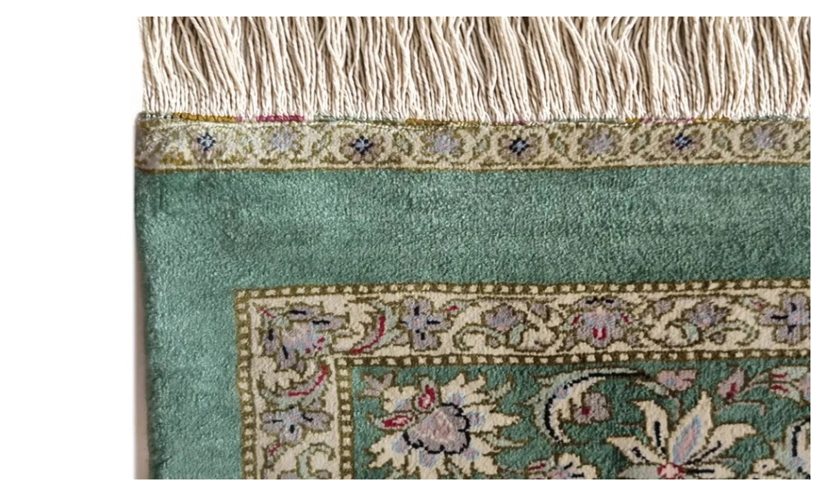 Green silk rug corner after fringe and selvedge restoration
